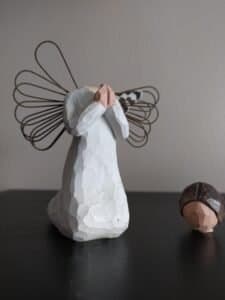 A small figurine of an angel kneeling in prayer