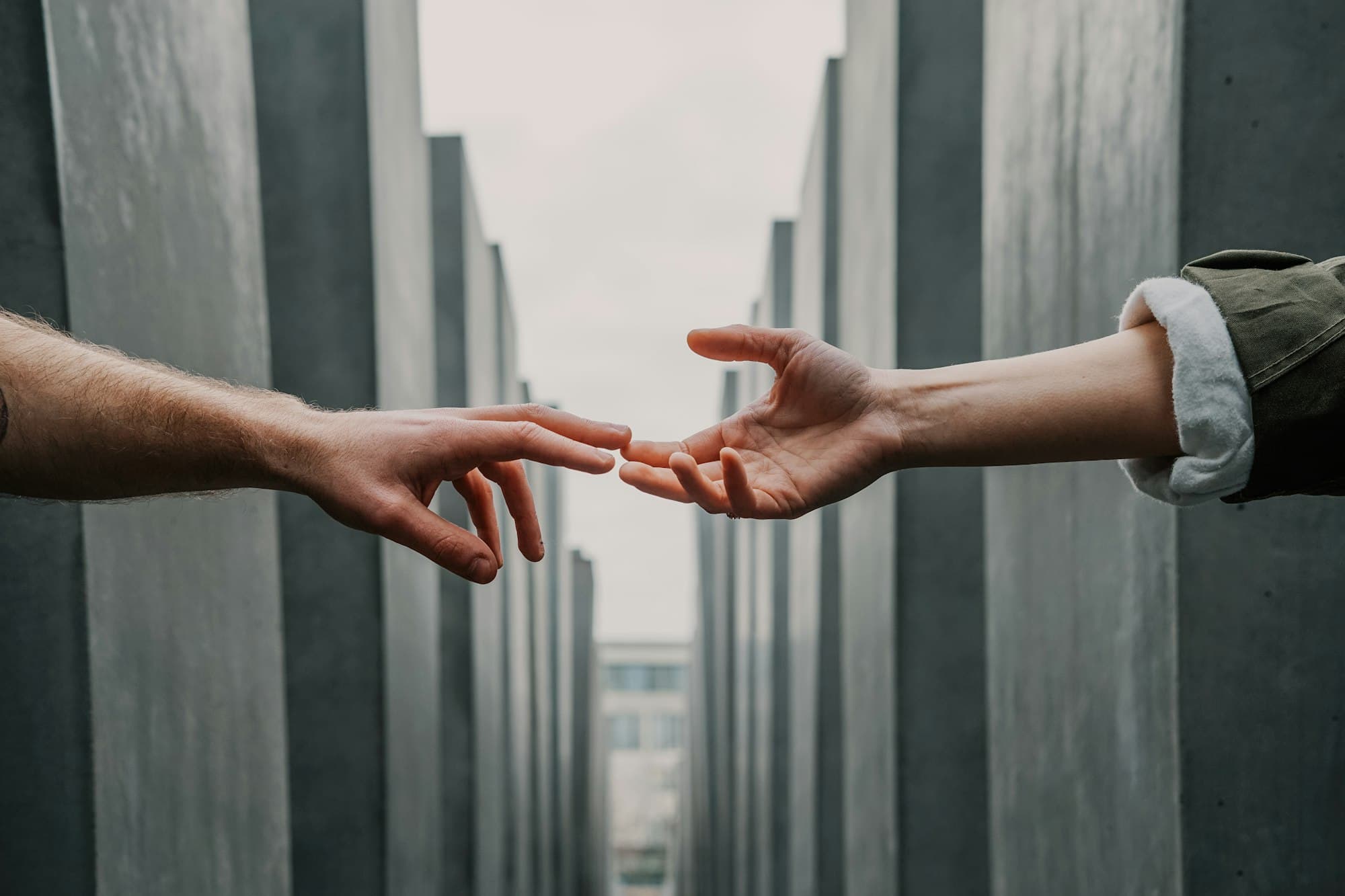 Two hands reaching toward each other