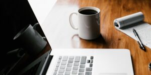 Open laptop with Bible and journal, symbolizing faith-based blog content from Thrive Ministries